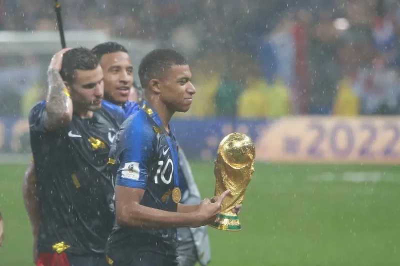 Kylian Mbappé with the 2018 Soccer World Cup trophy