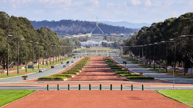 Anzac Parade from the Australian War Memorial in Canberra, ACT. In the distance is Old Parliament House, and behind that is the new Parliament House.