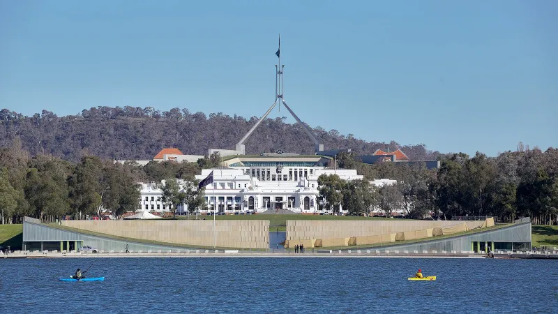 View from Lake Burley Griffin, in Canberra Australia. The older white building is Old Parliament House; the building behind it is the new Parliament House.